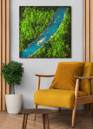 Yellow armchair in a room with a large framed picture of a river and greenery on the wall.