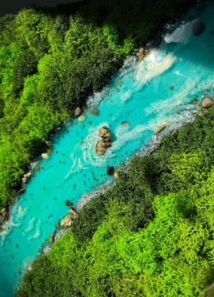 Turquoise river flowing through a lush green forest