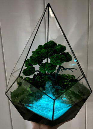 Preserved moss glass terrarium In the drop with waterfall glows in the dark