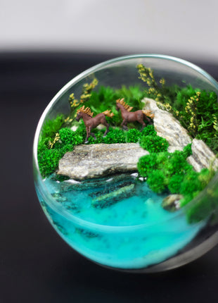 Preserved moss terrarium that glows in the dark with horses