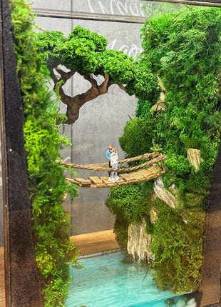 Terrarium "Forest Canyon" with preserved moss and a loving couple on a bridge with a lamp.