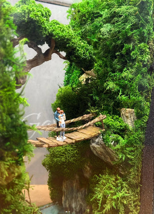 Terrarium "Forest Canyon" with preserved moss and a loving couple on a bridge with a lamp.