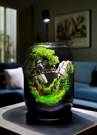 Jar with a miniature landscape inside, placed on a table in a living room setting.
