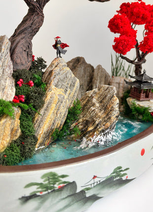 Close up of warrior figurine on rock among red bonsai trees and turquoise water